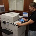 Student at print station in Belk Library