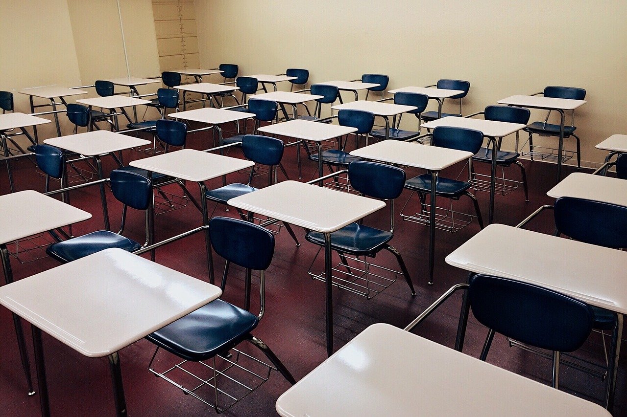 Image of empty desks in a classroom