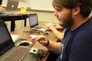 One of the workshop's attendees connecting his Arduino hardware to his computer for the coding portion. 