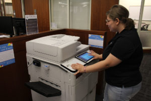 Student at print station in Belk Library